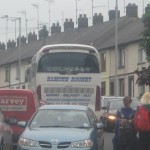 Traffic Chaos on route to hospital with vechicles mounting the pavements and Childrend an parents having to dodge out of the way